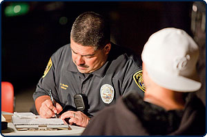 Image of an Officer writing a ticket