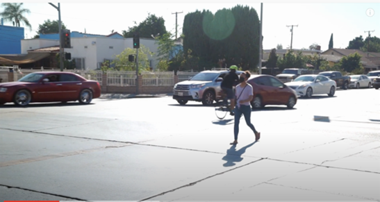 image of a woman walking across the street.